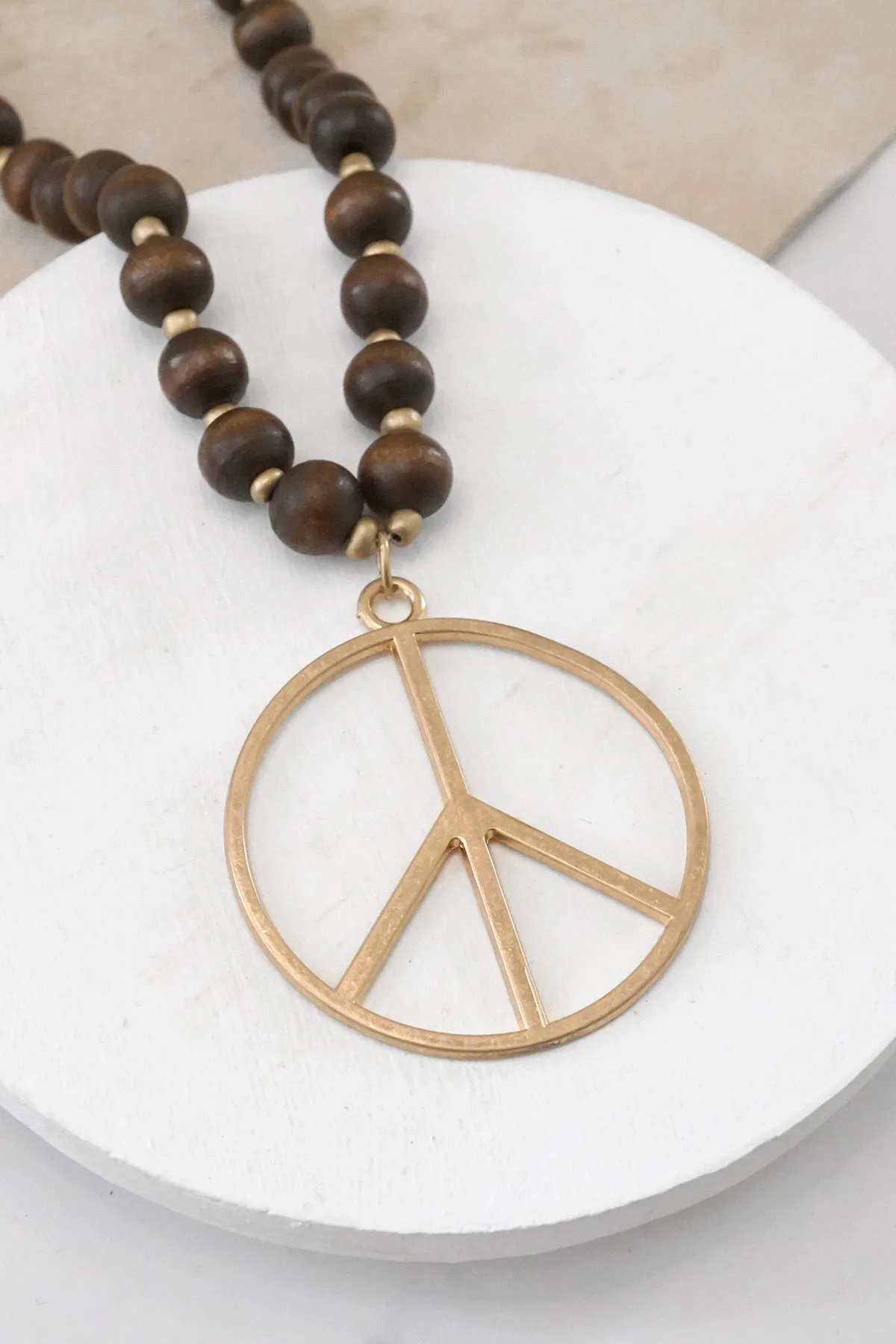 Long Wood Bead Necklace with golden peace sign pendant - Brown